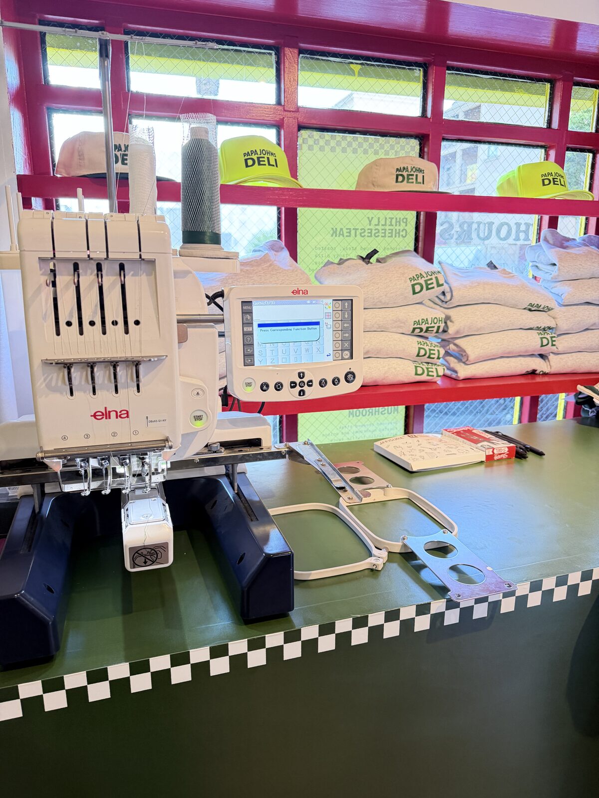 Live embroidery machine pop-up personalizing merchandise for guests